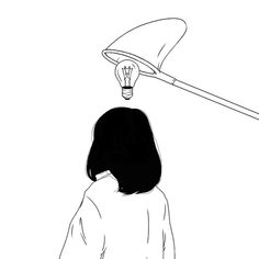 a woman looking up at a light bulb above her head