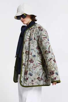 Lavenham Jacquard Shop Coat Floral Cream Originally designed to be worn whilst horse riding, Lavenham classics have long outgrown their equine roots to become mainstays of the modern wardrobe. Striking the balance between practical and put together, careful fit updates in recent years ensure a contemporary and comfortable silhouette whilst the skill and attention to detail in production give a premium finish.  A tried and tested Lavenham jacket silhouette reimagined in opulent Italian-made jacquard. A lift for any winter wardrobe.  Quilted with a compact yet warm wadding and in a simple vertical pattern allowing the fabric to take centre stage. Finished with two welt pockets, an organic cotton corduroy binding and button front fastening.  This jacket features a straight silhouette and slig Fall Jacquard Outerwear With Long Sleeves, Long Sleeve Jacquard Outerwear For Fall, Embroidered Outerwear For Daywear In Fall, Embroidered Outerwear For Fall Daywear, Embroidered Fall Outerwear For Daywear, Vertical Pattern, Centre Stage, Karen Walker, Modern Wardrobe