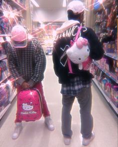 two people with hello kitty backpacks in a store