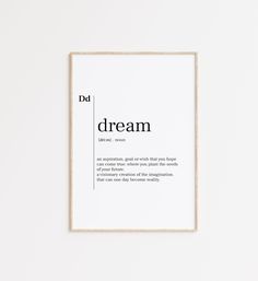 a framed poster with the words dream in black and white, against a white wall