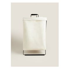 a white bag sitting on top of a black stand