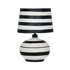 a black and white striped lamp on a table