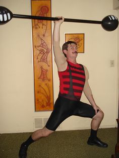 a man is doing an exercise with a barbell in his hand while standing on one leg