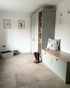 a room that has some shoes on the floor and a bench in front of it