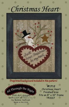 a cross stitch christmas heart with snowman on it