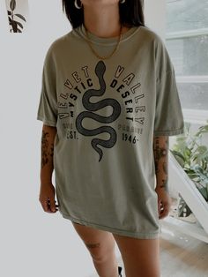 These tees are printed on super soft Comfort Colors, providing a relaxed unisex fit with a worn-in look and feel. This collection offers our most expanded size range from S-3X.Looking for these tees to fit oversized? Size up 1-2 sizes.Model is wearing a size XL for an oversized fit• 100% ring-spun cotton• Garment-dyed• Relaxed fitThis product is made especially for you as soon as you place an order, please see the banner on the top of our site for current turnaround times. Making products on dem Comfortable Graphic Print T-shirt, Sporty Acid Wash T-shirt For Spring, Trendy Acid Wash T-shirt For Streetwear, Trendy Oversized Acid Wash T-shirt, Trendy Acid Wash Tops With Front Print, Trendy Acid Wash Top With Front Print, Trendy Acid Wash T-shirt With Graphic Print, Acid Wash Graphic Tee With Front Print, Comfortable Graphic Print T-shirt For Streetwear