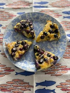 four slices of blueberry cheesecake on a plate