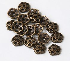 several bronze colored metal rings on a white surface