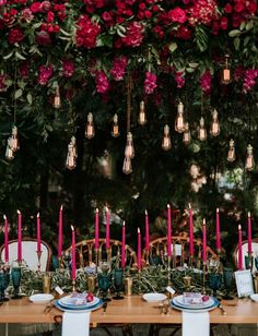 the table is set with candles and plates