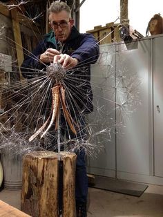 a man is working on some kind of sculpture