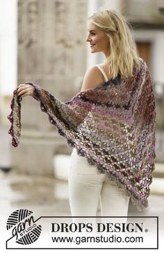 a woman in white pants and a purple shawl