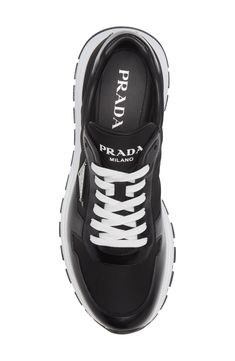 Prada takes steps toward being sustainable with this runner-inspired sneaker featuring a mixed design of leather and ECONYL® regenerated nylon. Lace-up style Leather and ECONYL textile upper/leather lining/synthetic sole ECONYL regenerated nylon is made with recovered nylon waste, such as fishing nets and fabric scraps Made in Italy Men's Designer Shoes Designer Running Sneakers, Dynamic Leather Sneakers With Air Cushioning, Calf Leather Sneakers With Vibram Sole For Streetwear, Leather High-top Sneakers With Air Cushioning For Sports, Sporty Leather Sneakers With Air Cushioning, Sporty Custom Leather Sneakers With Air Cushioning, Leather High-top Sneakers With Air Cushioning, Leather Sneakers With Reflective Details For Sports, Sporty Calf Leather Sneakers