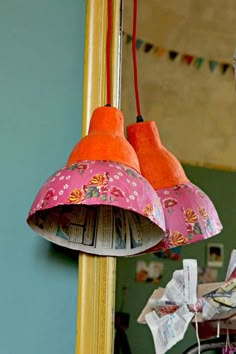 two lamps hanging from the ceiling in front of a mirror