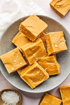 a bowl filled with peanut butter squares on top of a table