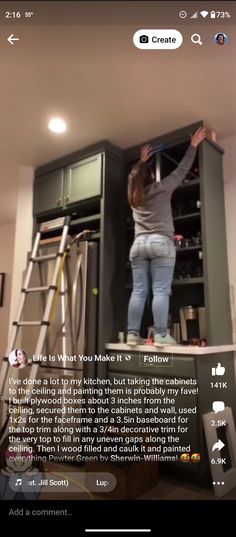 a woman standing on top of a ladder