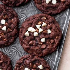 chocolate cookies with marshmallows are on a tray