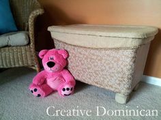 a pink teddy bear sitting next to a footstool