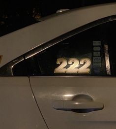 a white car with the number 22 on it's side window and door handle