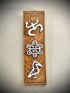 a wooden plaque with various symbols on it