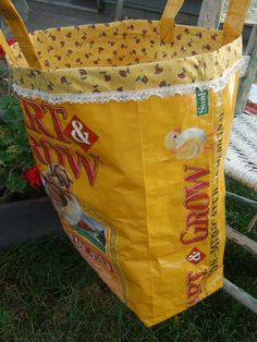 a yellow bag sitting on top of a grass covered ground