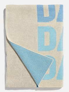 a blue and white blanket with the word dad printed on it's bottom corner