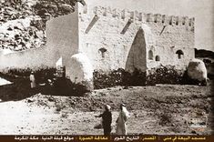 an old black and white photo of two people in front of a castle