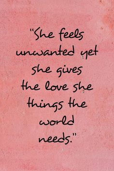 a pink wall with black writing that says she feels unwantedly yet she gives the love she thinks the world needs