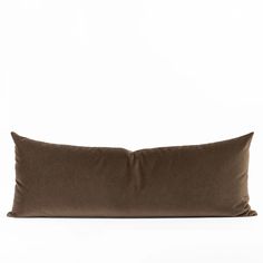 a brown pillow sitting on top of a white surface