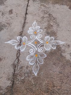 an artistic design on the ground painted with white and yellow paint is seen in this image