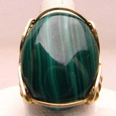 "Handmade 14kt Gold Filled Wire Wrap Green Malachite Ring Sizing and shipping is ALWAYS FREE with a 14 day \"No Questions Asked\" return policy. Gemstone sizes available: XS (16x12mm 5/8x1/2 inch) S (18x13mm 3/4x1/2 inch 10+ct) M (25x18mm 1x3/4 inch 20+ct) L (30x22mm 11/8 x7/8 inch 25+ct) This ring is made with real gems. I made it myself, so if you see a setting you like and want a different gem in it, I can put in another one as they are not finished. I can probably do it for the same price or Malachite Ring, Malachite Rings, Faceted Gems, Green Malachite, Custom Ring, Wire Wrapped Rings, Ring Handmade, Wire Wrap, 14kt Gold