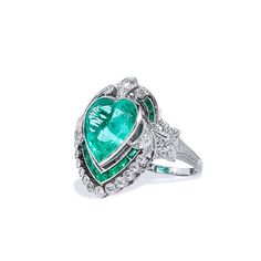 Crafted in platinum, this Art Deco style ring chants true love and uniqueness. The piece features a stunning 5.87ct Columbian heart shape Emerald surrounded by 1.03ct of additional emeralds. SKU: 16866 Colombian Emerald Ring, Emerald Set, Columbian Emeralds, Estate Ring, Estate Rings, Colombian Emeralds, Platinum Metal, Emerald Ring, Selling Jewelry