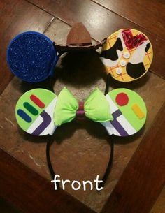 three mickey mouse ears with different colors and designs on them, one has a bow