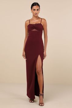 a woman wearing a long dress with a slit down the side and spaghetti straps on it