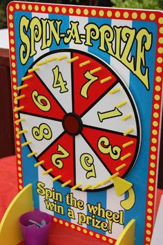 a child is playing with a spin - a - prize game