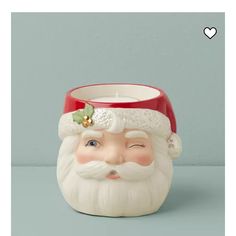 a candle holder with a santa face on it