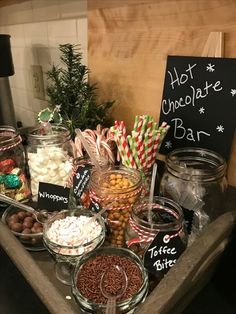 a wooden table topped with lots of different types of candy and candies on top of it