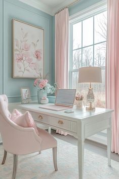 a desk with a laptop computer on top of it next to a pink chair in front of a window