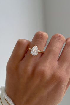 a woman's hand with a diamond ring on it