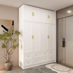 a bathroom with white cabinets and a plant in a vase on the floor next to it