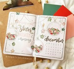 an open planner with christmas decorations on it