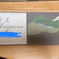 the wedding stationery is designed to look like it has mountains and blue water on it