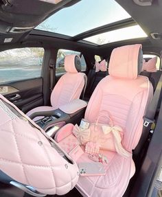 the interior of a car with pink leather seats and bows on it's headrests