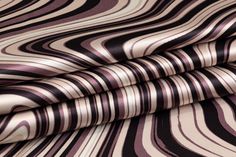 a close up view of a purple and black pattern on a bed sheet that has been made to look like an abstract design