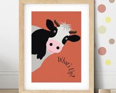 a black and white cow on an orange background with the words what's up?