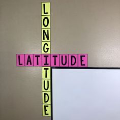 a cross made out of scrabble tiles with the words latitude on it