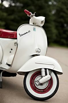 a white scooter is parked on the street