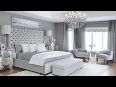 a bedroom with gray walls and white furniture