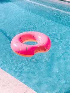 an inflatable donut floating on the side of a swimming pool