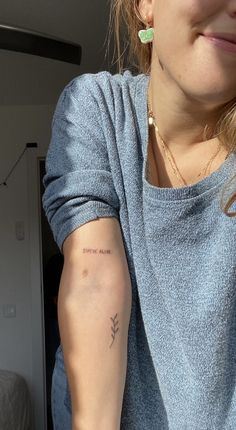 a woman with a small tattoo on her arm