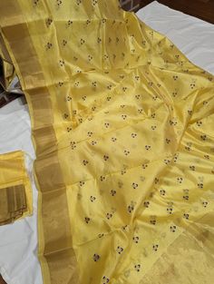 It is a bright and beautiful yellow and gold combination of pure Chanderi Silk saree with an all-over blue-gold zari flower buttas and gold plain weaved border. Roopayan Boutique specializes in exclusive designer and traditional sarees from different parts of India. Our 20 years of experience in the business promises you the richest quality clothing at an affordable price. *.Item: Saree and Unstitched blouse fabric. *.Condition: New * Occasion: Party, Eveningwear, wedding * Base Fabric: Chanderi Silk * Has blouse piece: Yes  * Blouse Fabric: blouse PC in yellow & gold * Work: Zari Work . Fall/Pico: Done *Note: Due to lighting conditions and screen settings color and shading may slightly vary. This is a handmade product any minor inconsistency in weaving is natural and lend to the individua Yellow Bollywood Traditional Wear For Transitional Season, Designer Raw Silk Traditional Wear In Gold, Yellow Traditional Wear With Zari Work For Transitional Season, Transitional Traditional Wear With Zari Work In Yellow, Gold Traditional Wear With Cutdana For Transitional Season, Elegant Yellow Traditional Wear With Cutdana, Yellow Cutdana Raw Silk Blouse Piece, Transitional Gold Chanderi Traditional Wear, Gold Chanderi Traditional Wear For Transitional Season